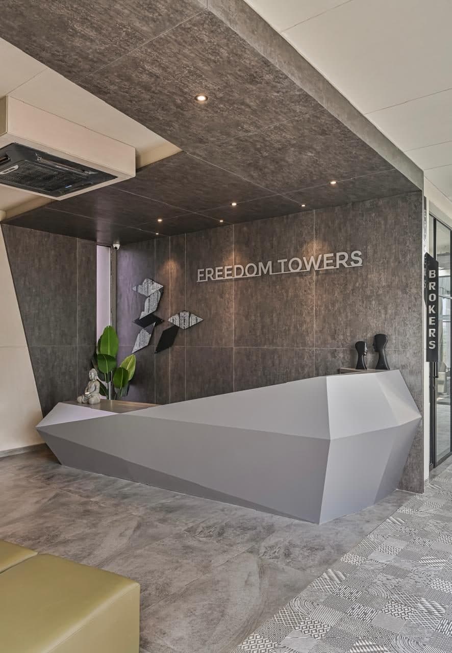 Freedom Towers — The sculptural reception counter and signage wall